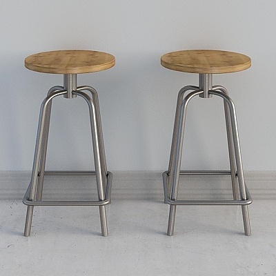 Two modern round bar stools with light wood seats and silver metal legs on grey background