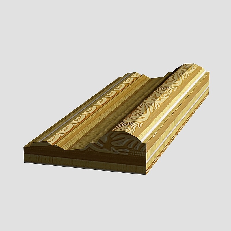 Ornate gold decorative molding piece with floral patterns on grey background