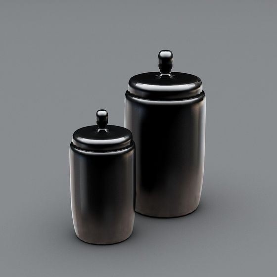 Two black ceramic kitchen canisters with lids and small knobs on grey background
