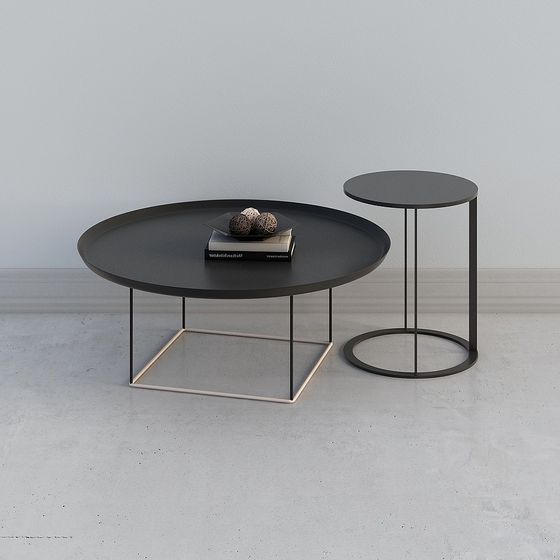 Modern round coffee table set with black metal frame and grey top on white background