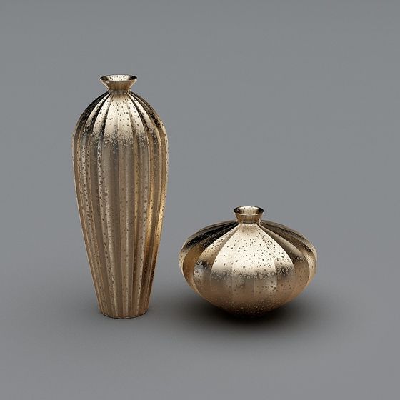 Two gold metal vases with vertical ridges and speckled finish on grey background