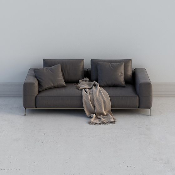 Modern dark grey leather sofa with pillows and blanket on white background