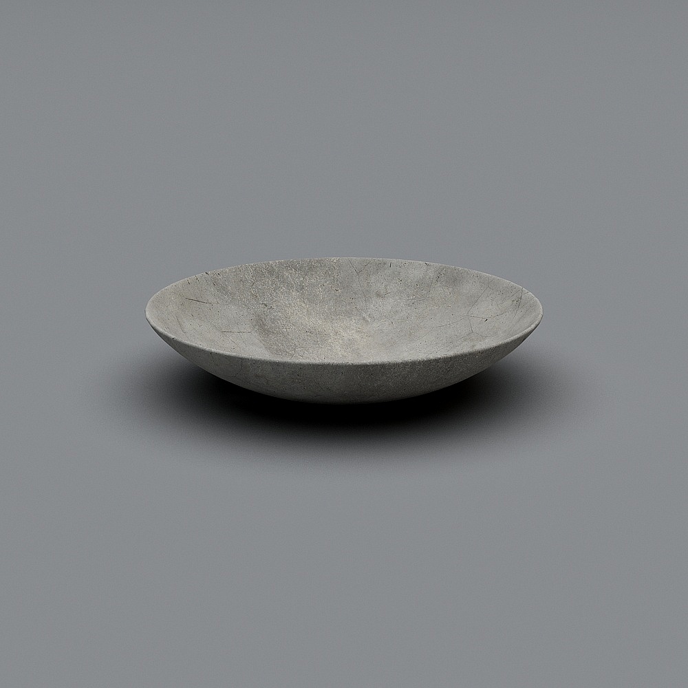 Modern grey stone serving bowl with textured surface on grey background