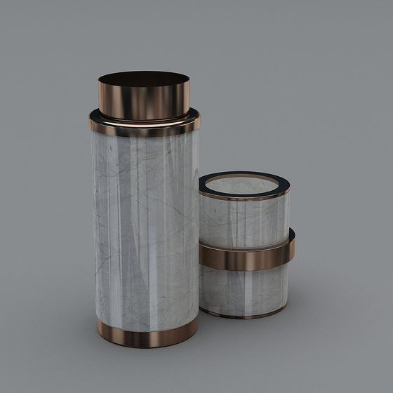Two cylindrical marble containers with bronze metal rims on grey background