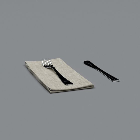 Black metal fork and spoon on folded beige cloth napkin on grey background